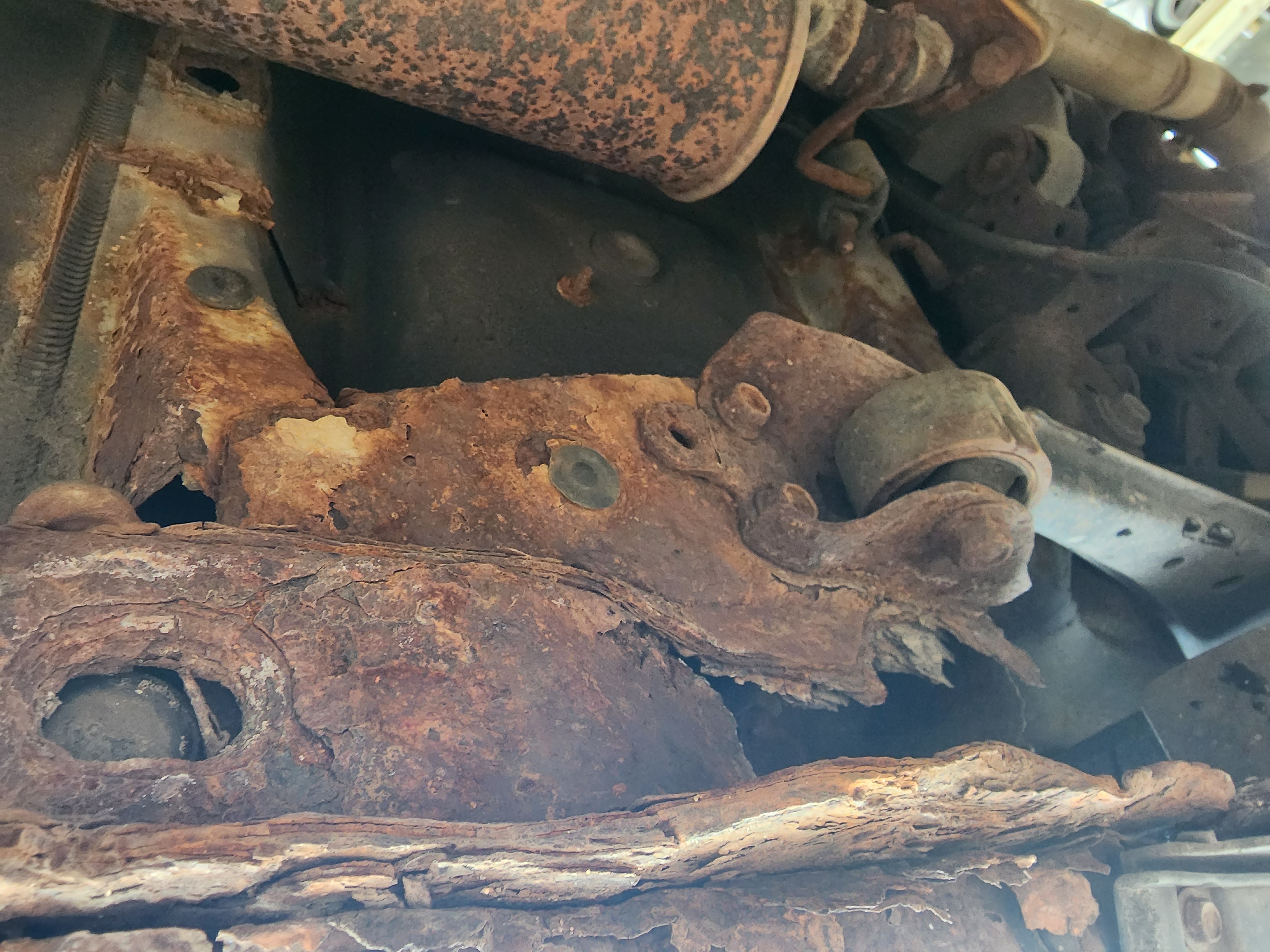 The rust around the trailing arm, before it was fixed